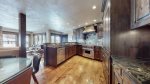 Gourmet fully equipped kitchen with granite countertops and stainless steel appliances 